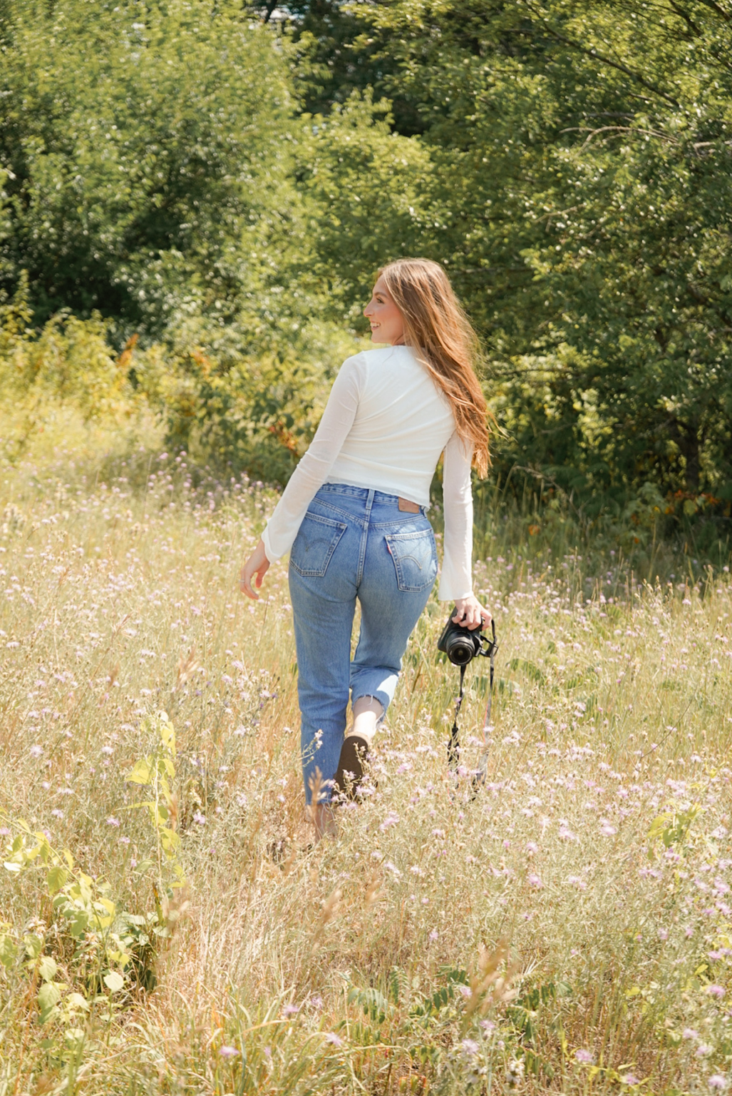 Lexus with a camera in a sunlit West Michigan field