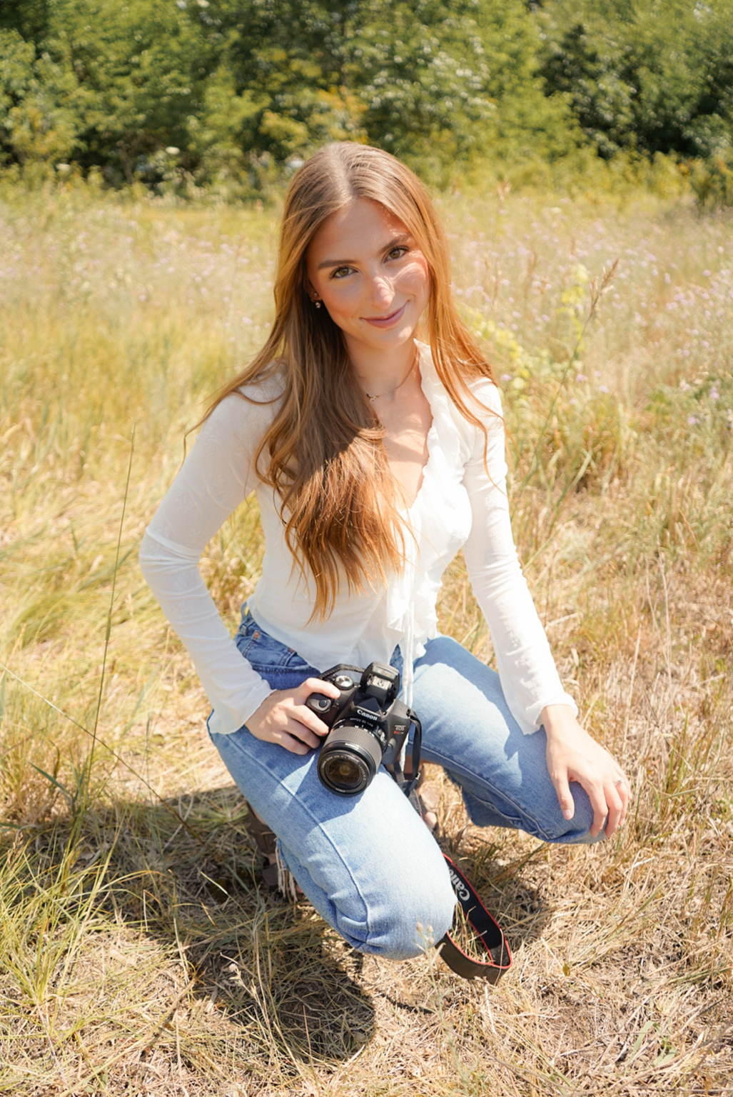 Lexus holding her camera in warm natural light