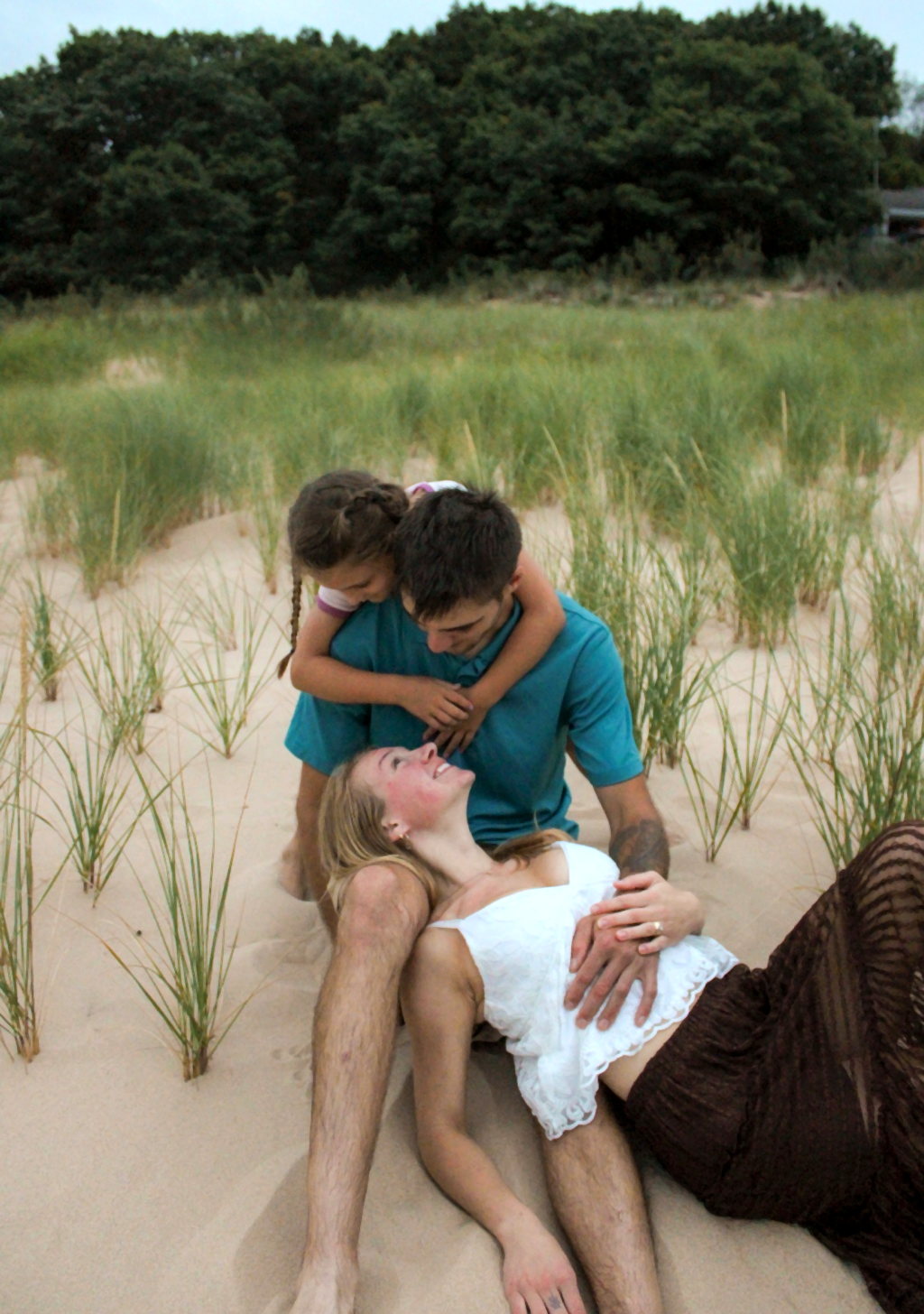 Family relaxing together in beach grass